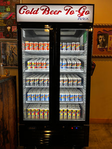 Reach-in cooler with double glass doors, full of six-packs of beer
